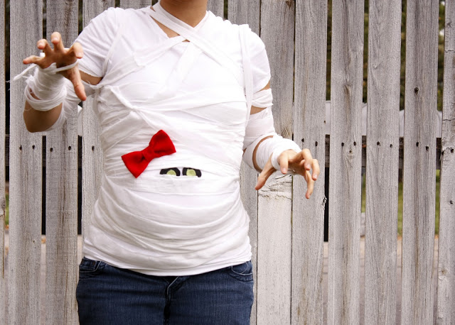 Pregnant woman wrapped up to look like a mummy