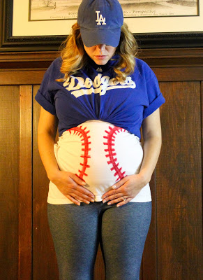 Pregnant woman with belly dressed up as baseball